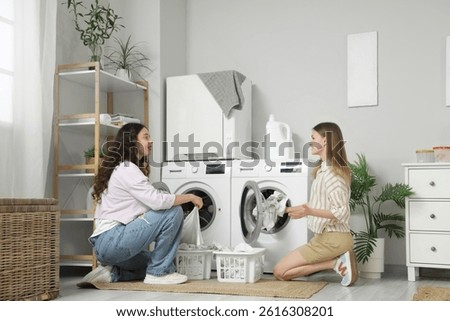 Female students doing laundry in dormitory