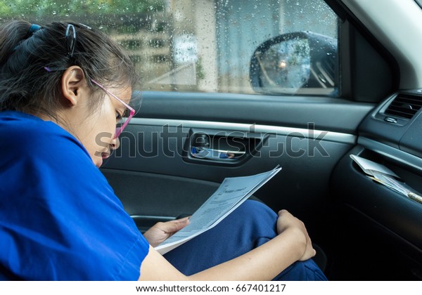 Female\
students are reading in the car\
in-THAILAND.