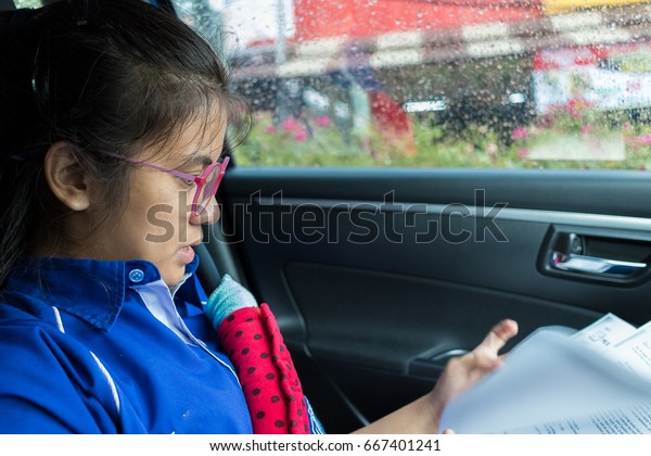 Female\
students are reading in the car\
in-THAILAND.