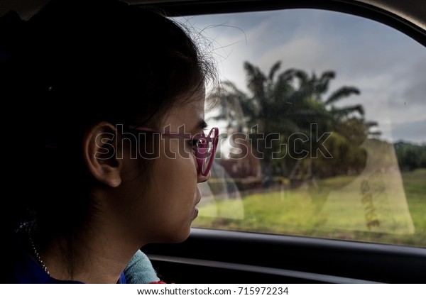 Female students\
wear glasses good Fed up with in the car on the road as traffic\
jams in the morning.\
in-THAILAND.