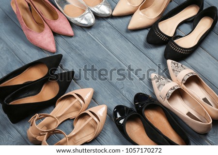 Female stylish shoes on wooden background