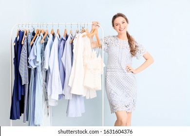 Female Stylist Near Rack With Modern Clothes