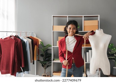 Female stylist Successful Fashion Business. Portrait of Smiling Black Designer stylish standing and working at fashion studio. Portrait of fashion designer in office. - Powered by Shutterstock