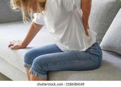 Female suffer from low back pain. Hand of american woman holding her waist backache in pain. Health care concept - Shutterstock ID 2186584149
