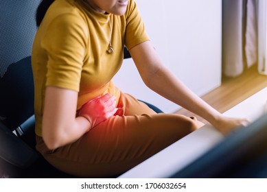 Female suffering from abdominal pain,Period cramps,Hands squeezing belly,Stomach pain,Woman having painful stomach ache during working at home