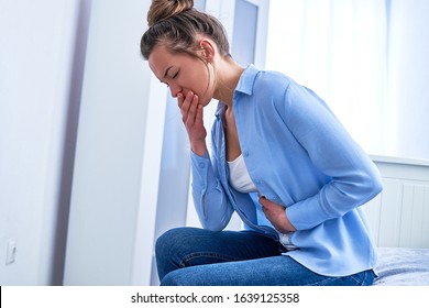 Female Suffers From Nausea And Vomiting Due To Digestive And Stomach Illness Problems And Gastrointestinal System Diseases Or Food Poisoning. Morning Toxicosis In First Trimester Of Pregnancy