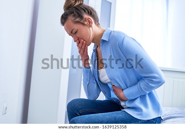 Female suffers from nausea and vomiting due to\
digestive and stomach illness problems and gastrointestinal system\
diseases or food poisoning. Morning toxicosis in first trimester of\
pregnancy