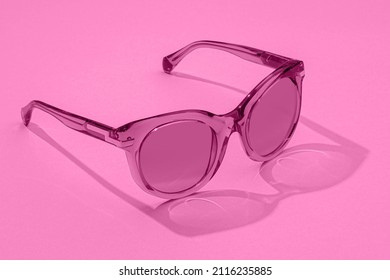 Female Sunglasses in beautiful fashion pink minimal concept  New 2022 trending PANTONE pink color