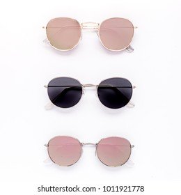 Female Sunglasses On White Background. Flat Lay, Top View. 