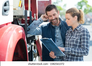 Female Supervisor Next To Lorry Driver