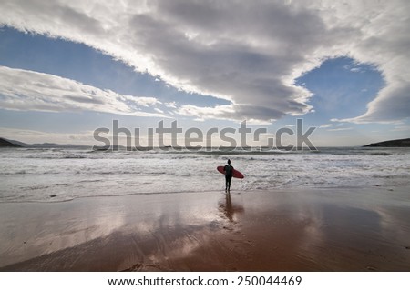 Female surfer in cloudy winter weather