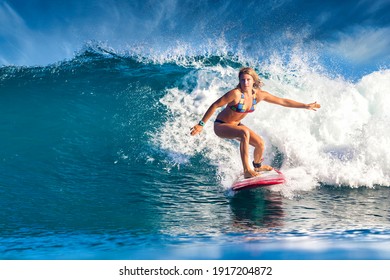 Female Surfer On A Blue Wave At Sunny Day