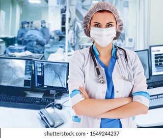 Female surgeon doctor at operation. Interventional cardiology. . Visualization on the monitor in the operating x-ray lab on background