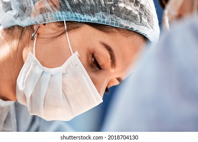 Female Surgeon In Operating Room Close-up, Woman Doctor Face During Operation