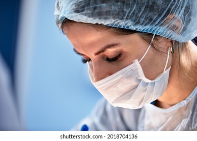 Female Surgeon In Operating Room Close-up, Woman Doctor Face During Operation