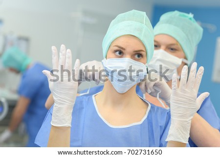 female surgeon preparing for surgery