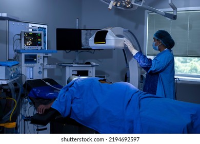  Female Surgeon Setting Up Machine To Take Xray Of Patient At Hospital Operating Room