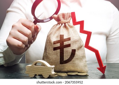 Female Surveyor Examines A Turkish Lira Money Bag With A Red Down Arrow And Auto. Electric Vehicle Support Subsidies. ICE. Car Insurance, Maintenance. Fuel Excise Taxes. Falling Sales Revenue