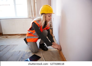 Female Surveyor In Hard Hat And High Visibility Jacket With Digital Tablet Carrying Out House Inspection - Shutterstock ID 1273188118