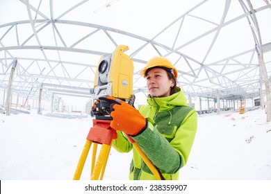 Female Surveyor Worker Working With Theodolite Transit Equipment At Road Construction Site Outdoors