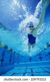 Female swimmer gushing through water in pool