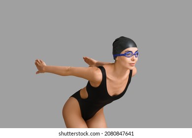 Female Swimmer On Grey Background