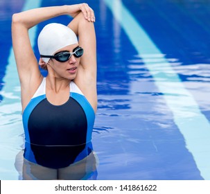 Female Swimmer Stretching Before Workout At The Pool