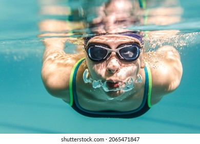 Female Swimmer At The Swimming Pool.Underwater Image.