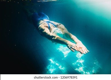 Female swimmer at the swimming pool.Underwater photo. - Shutterstock ID 1206978391