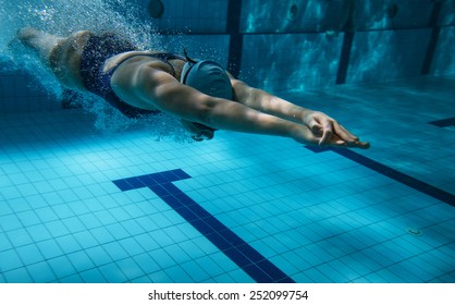 Female swimmer at the swimming pool.Underwater photo.