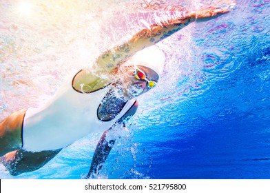 Female Swimmer With Tattoos. Underwater Shoot