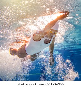 Female Swimmer With Tattoos. Underwater Shoot