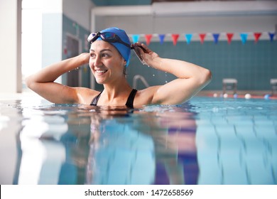 Female Swimmer Wearing Hat And Goggles Training In Swimming Pool - Shutterstock ID 1472658569