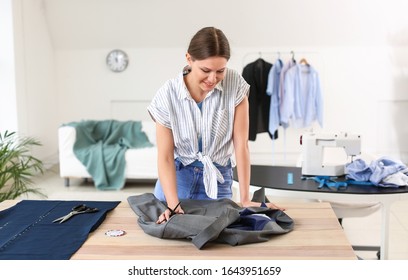 Female Tailor Working In Atelier