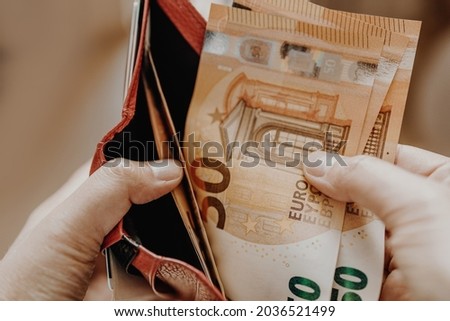 Female taking out euro money from her pocket wallet. Man counting money, economy concept, money distribution