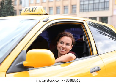 Female taxi driver in car