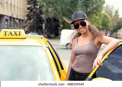 Female Taxi Driver Near Car