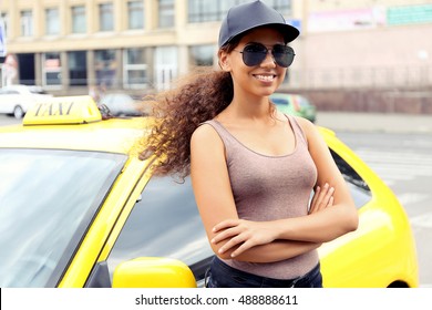 Female Taxi Driver Near Car