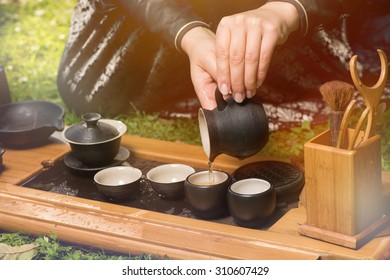 Female Tea Master Making Chinese Tea Ceremony In Garden