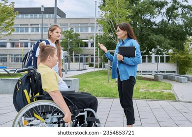 Female teacher and children, boy in wheelchair and girl talking outdoor - Powered by Shutterstock