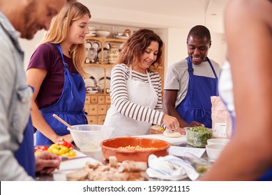 Female Teacher Demonstrating How To Use Dough To Make Flatbread In Cookery Class