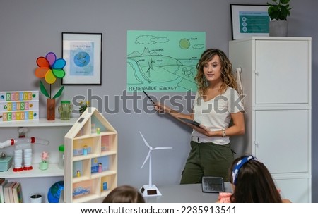 Similar – Image, Stock Photo Teacher explaining types of renewable energies in poster at ecology classroom