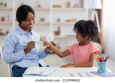 Female Teacher Friendly Pretty Young Black Woman And Little Girl Preschooler Exercising At Daycare, Learning About Emotions, Copy Space. Child Development, Emotional Intelligence For Kids Concept