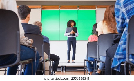 Female Teacher Giving Presentation To High School Or University Class In Front Of Green Screen - Powered by Shutterstock