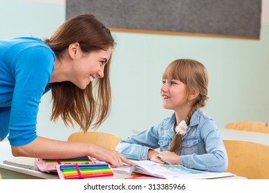 Female Teacher Shows The Children The Book, Reading