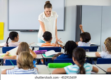 Female Teacher Teaching Children In Classroom