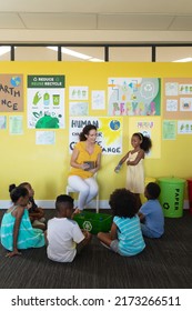 Female Teacher Teaching Importance Of Recycling To Multiracial Students In Classroom, Copy Space. Unaltered, Education, Learning, Promote Benefit Of Recycling, Responsibility And Environmental Issue.