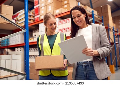 Female Team Leader With Clipboard In Warehouse Training Intern Standing By Shelves - Powered by Shutterstock