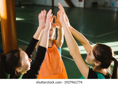Female Team Players Giving High Five Before The Indoor Female Volleyball Match . Team Spirit Ready To Championship. Sport Club Community, Sports And Healthcare Concept