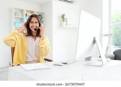 Female technical support agent at table in office